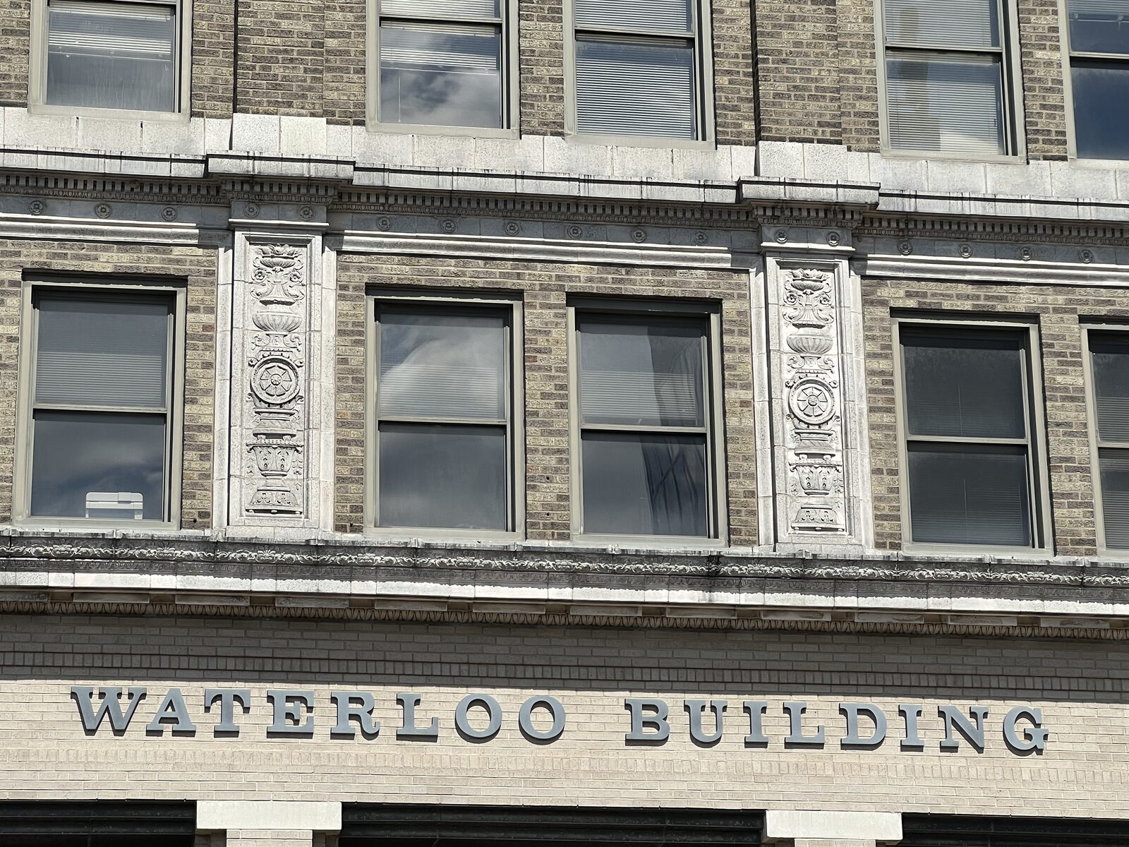 The carved WATERLOO BUILDING sign on the facade at 531 Commercial Street, Waterloo, Iowa